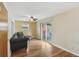 Cozy living room featuring hardwood floors and sliding glass doors to the backyard at 410 E Southport Rd, Indianapolis, IN 46227