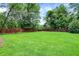 Expansive backyard with lush green lawn and a privacy fence, ideal for outdoor activities at 4125 S Post Rd, Indianapolis, IN 46239