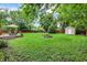 Lush green backyard with a wooden privacy fence, shed, and a patio set at 4125 S Post Rd, Indianapolis, IN 46239