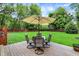 An inviting backyard deck with an umbrella-covered table set for outdoor enjoyment at 4125 S Post Rd, Indianapolis, IN 46239
