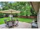 Outdoor deck with dining set and umbrella overlooking a beautiful yard and shed at 4125 S Post Rd, Indianapolis, IN 46239