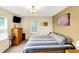 Comfortable bedroom with natural light, dresser, TV and a cozy patterned bedspread at 4125 S Post Rd, Indianapolis, IN 46239