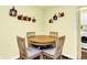Cozy dining area featuring a round table with wooden chairs, adjacent to kitchen and laundry room at 4125 S Post Rd, Indianapolis, IN 46239