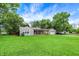 Well-maintained single story home with stone and siding exterior, plus a lush front yard and mature trees at 4125 S Post Rd, Indianapolis, IN 46239