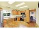 Well-lit kitchen with stainless steel appliances, ample counter space, and wooden cabinets, ideal for cooking and entertaining at 4125 S Post Rd, Indianapolis, IN 46239