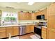 Well-lit kitchen with stainless steel appliances and wood cabinets at 4125 S Post Rd, Indianapolis, IN 46239