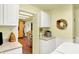 Cozy laundry space adjacent to dining area, featuring white cabinets and modern appliances at 4125 S Post Rd, Indianapolis, IN 46239