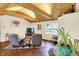 Inviting living room featuring wood-beamed ceilings, comfortable seating and bright windows at 4125 S Post Rd, Indianapolis, IN 46239