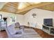 Bright living room with wood-beamed ceilings, comfortable seating and lots of natural light at 4125 S Post Rd, Indianapolis, IN 46239