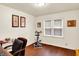 Home office with wood flooring, window with blinds, and exercise bike at 4125 S Post Rd, Indianapolis, IN 46239