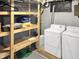 Functional basement space with washer, dryer, and storage shelves at 4345 Guilford Ave, Indianapolis, IN 46205