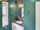 Stylish bathroom features round mirror, eye catching wallpaper, and sleek vanity at 4345 Guilford Ave, Indianapolis, IN 46205
