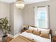 Bedroom with hardwood floors, a minimalist aesthetic, and natural light exudes serene comfort and modern style at 4345 Guilford Ave, Indianapolis, IN 46205