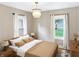 Comfortable bedroom with a wooden bed frame, natural light, and a minimalist aesthetic providing a peaceful retreat at 4345 Guilford Ave, Indianapolis, IN 46205