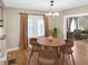 Inviting dining room featuring hardwood floors and a stylish chandelier with great access to the living room at 4345 Guilford Ave, Indianapolis, IN 46205