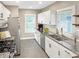 Bright kitchen with stainless steel appliances, granite countertops, and white cabinetry offers a modern aesthetic at 4345 Guilford Ave, Indianapolis, IN 46205