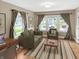 Cozy living room featuring hardwood floors, comfortable seating, and an abundance of natural light at 4345 Guilford Ave, Indianapolis, IN 46205