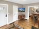 Open-concept space with wood floors, a mounted TV, and seamless flow into the dining area at 4345 Guilford Ave, Indianapolis, IN 46205