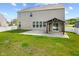 Spacious backyard features a covered patio and manicured lawn. The house has lots of windows at 4539 Maldenhair Dr, Indianapolis, IN 46239