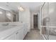 Modern bathroom features double sink vanity, a walk-in shower, and access to closet at 4539 Maldenhair Dr, Indianapolis, IN 46239