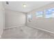 Well-lit bedroom features neutral walls, carpet flooring, and double-paned windows offering natural light at 4539 Maldenhair Dr, Indianapolis, IN 46239