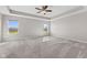Spacious bedroom offers tray ceiling, carpet flooring and bright, sun-filled windows at 4539 Maldenhair Dr, Indianapolis, IN 46239