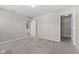 Comfortable bedroom with neutral walls, carpet floors, and an open doorway at 4539 Maldenhair Dr, Indianapolis, IN 46239