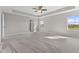 Expansive bedroom with tray ceiling, carpet floor, and abundant natural light from large windows at 4539 Maldenhair Dr, Indianapolis, IN 46239