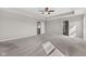 Large bedroom featuring tray ceiling, carpet floor, and a doorway to an adjoining room at 4539 Maldenhair Dr, Indianapolis, IN 46239