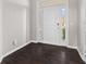 Inviting foyer features dark hardwood floors, a white front door with sidelights, and neutral wall paint at 4539 Maldenhair Dr, Indianapolis, IN 46239