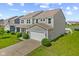 Beautiful two-story home with gray siding, attached garage, and well-kept lawn in a quiet neighborhood at 4539 Maldenhair Dr, Indianapolis, IN 46239