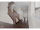 Hallway with a dark wood staircase and access to the main entrance at 4539 Maldenhair Dr, Indianapolis, IN 46239