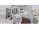 Contemporary kitchen featuring white cabinets, a center island, stainless steel appliances, and dark wood flooring at 4539 Maldenhair Dr, Indianapolis, IN 46239
