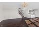 Open concept living room with a staircase, dark hardwood floors, and access to the kitchen at 4539 Maldenhair Dr, Indianapolis, IN 46239