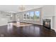 Bright living room with a fireplace, large windows, hardwood floors, and access to the backyard at 4539 Maldenhair Dr, Indianapolis, IN 46239