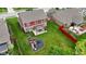 Aerial view of the backyard, featuring a patio with pergola and a playground, ideal for outdoor living at 4683 W Lawrence Way, New Palestine, IN 46163