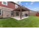 A well-maintained backyard features a beautiful pergola with string lights for evening ambiance at 4683 W Lawrence Way, New Palestine, IN 46163