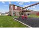Backyard with swing set and a patio with pergola, combining play and relaxation spaces at 4683 W Lawrence Way, New Palestine, IN 46163