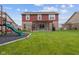 Backyard with patio, pergola, and playground offers a blend of relaxation and recreation space at 4683 W Lawrence Way, New Palestine, IN 46163