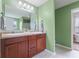 Bathroom features light green walls, a double sink vanity, and a large mirror on the left side of the image at 4683 W Lawrence Way, New Palestine, IN 46163
