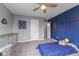 Cozy bedroom featuring a modern ceiling fan, gray walls, and an accent wall with blue paneling at 4683 W Lawrence Way, New Palestine, IN 46163