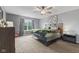 Bedroom with a window, ceiling fan, neutral gray walls, and gray and green colored bedding on the bed at 4683 W Lawrence Way, New Palestine, IN 46163