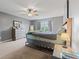 Bedroom with gray walls, a window, modern furniture, and neutral carpet beneath a flat-screen television at 4683 W Lawrence Way, New Palestine, IN 46163