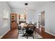 Stylish dining room featuring a rustic wooden table, modern lighting, and hardwood floors at 4683 W Lawrence Way, New Palestine, IN 46163