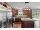 Well-equipped kitchen with stainless steel appliances, wood cabinets, and center island at 4683 W Lawrence Way, New Palestine, IN 46163