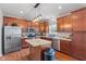 This bright kitchen features wood cabinets, stainless steel appliances, and a center island at 4683 W Lawrence Way, New Palestine, IN 46163