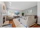 Spacious living room with fireplace, gray walls, hardwood floors and lots of comfortable seating at 4683 W Lawrence Way, New Palestine, IN 46163