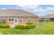 Beautiful backyard with green grass, brick home, and paver patio at 4725 W Harrisburg Ct, New Palestine, IN 46163