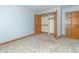 Bedroom boasts carpet flooring, neutral paint, and an open closet at 4725 W Harrisburg Ct, New Palestine, IN 46163
