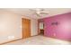 Bright bedroom with ceiling fan, and open doorway leading to a bathroom at 4725 W Harrisburg Ct, New Palestine, IN 46163